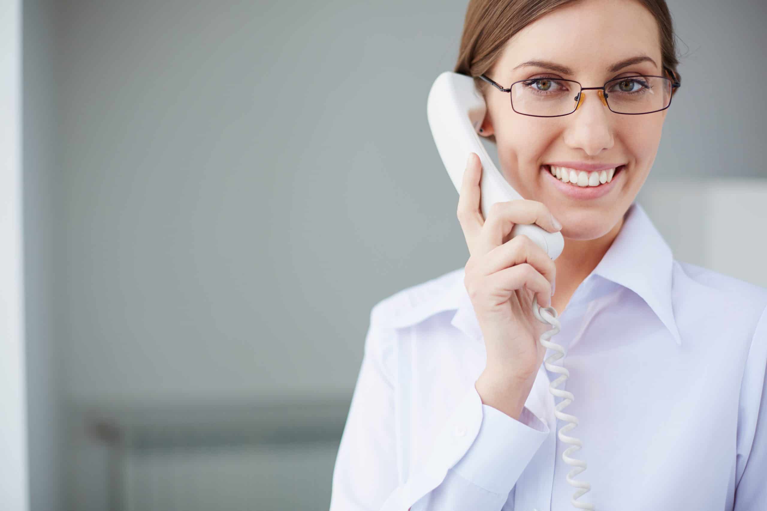 Young businesswoman looking at camera while speaking on the phone
